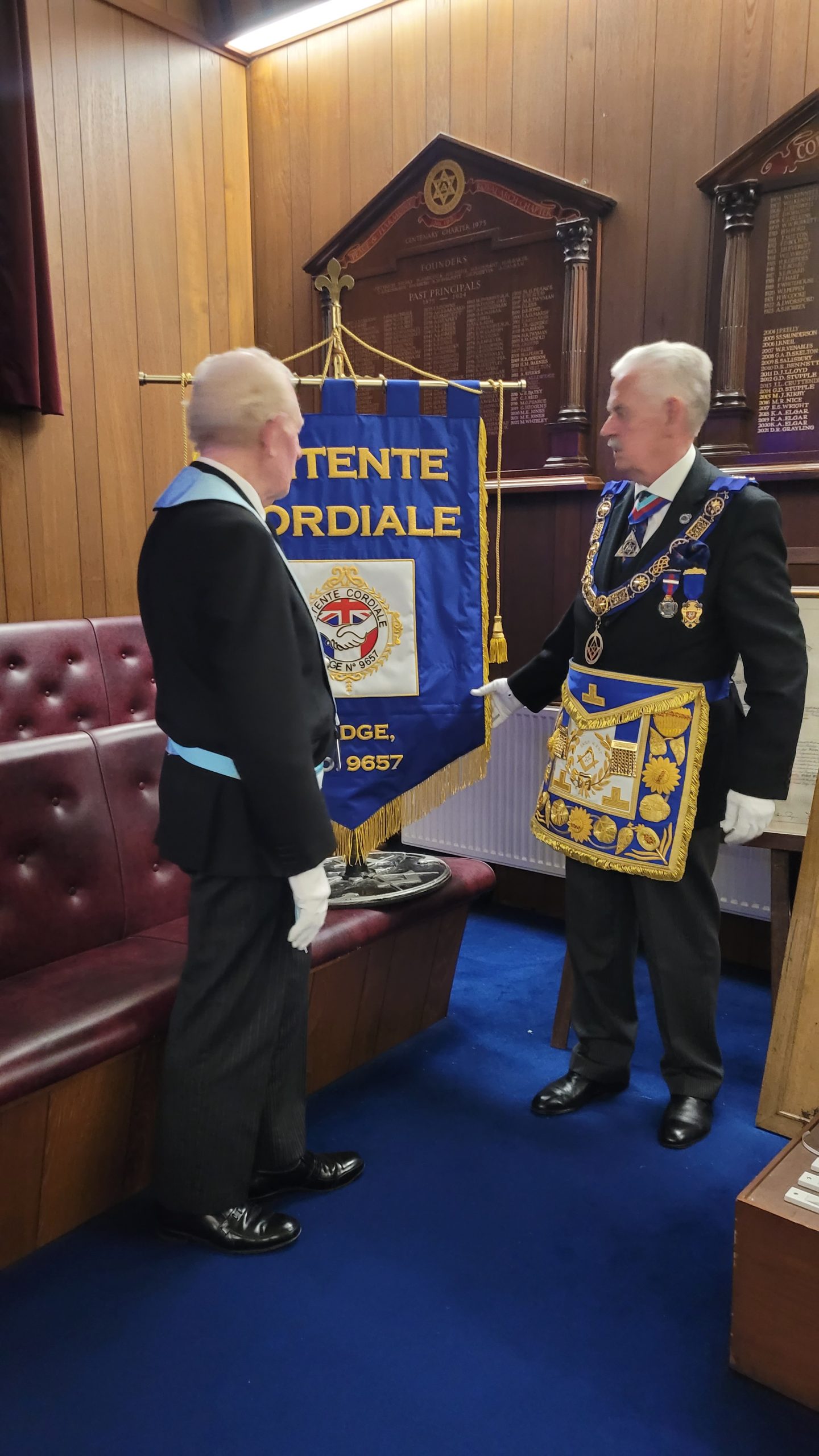 The PGM unveils the Lodge banner with the WM looking on.