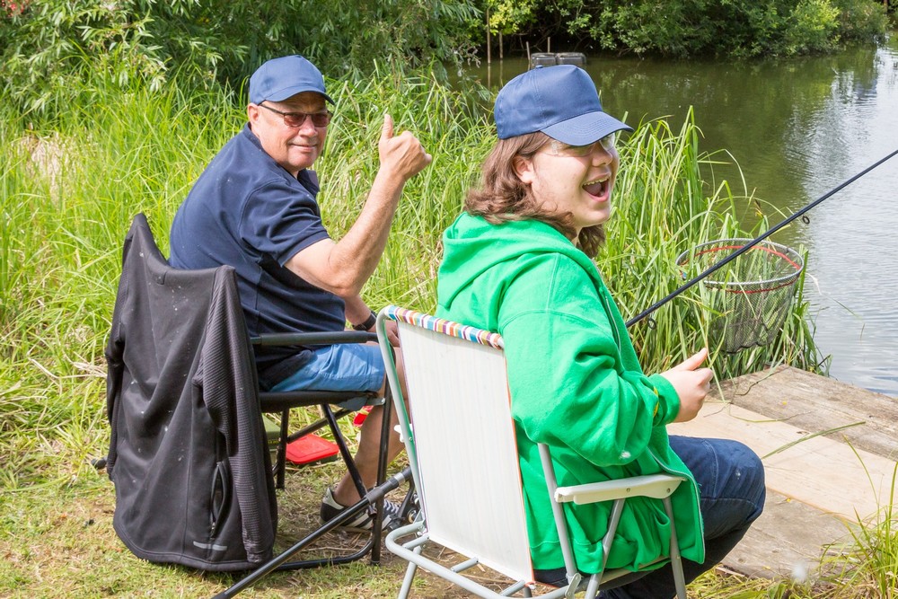 picture of a caster and one of the students enjoying the fishing