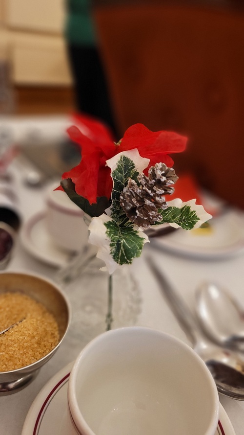 a lovely table decoration by mrs gibbons, holly and a red pointsettia