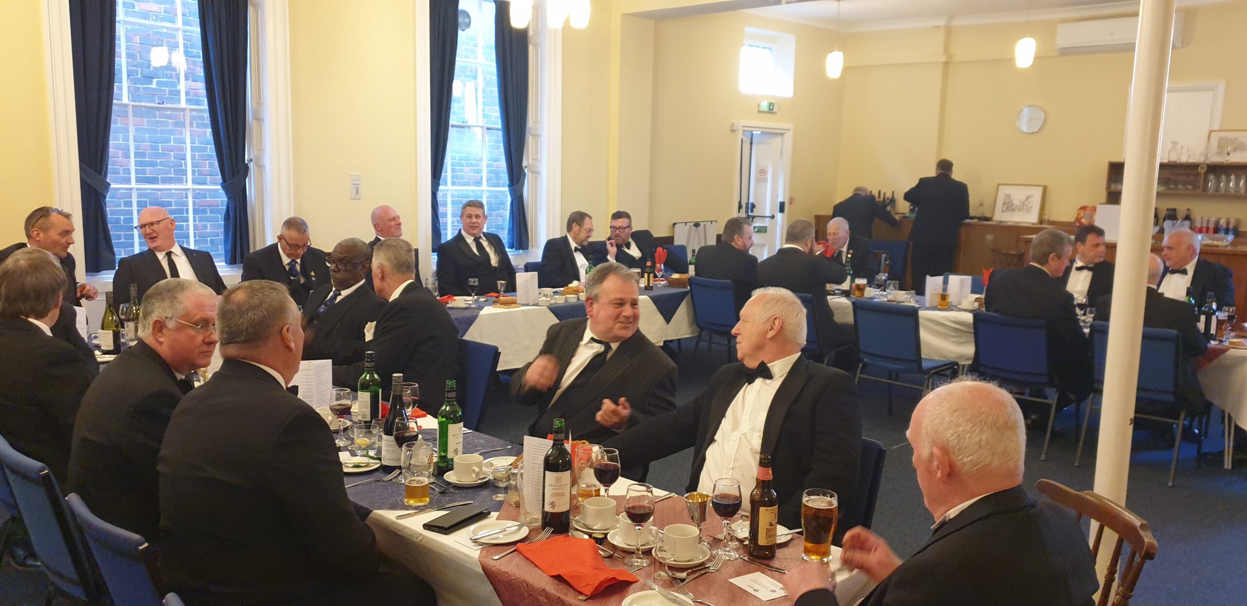 A photo of lodge members enjoying each others company at the festive board meal. 
