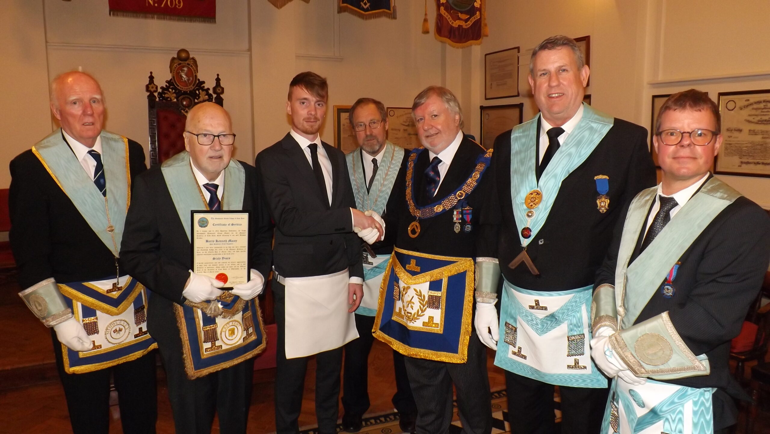 group photo of Matthew Harrison the new entrant shaking hands with the Deputy Provincial Grand Master Phil South