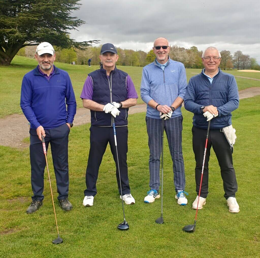 The Captains Leon Zacharow & Archie Torrance and two other golfers stand on the first tee, drivers ready for the round of golf