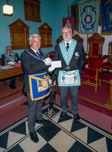 A picture of The Lodge Charity Steward Bro Eric Cook presented a cheque for £1000 to APGM Mark Bassant as contribution towards the 2025 Festival. The Lodge has already achieved a silver certificate and aims to achieve Gold by the end of 2023.