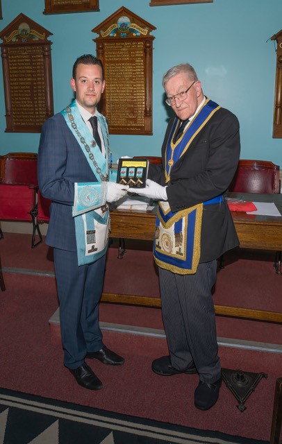 Picture of The longest serving member of the Lodge W Bro Richard Parks, presenting the jewels to the lodge