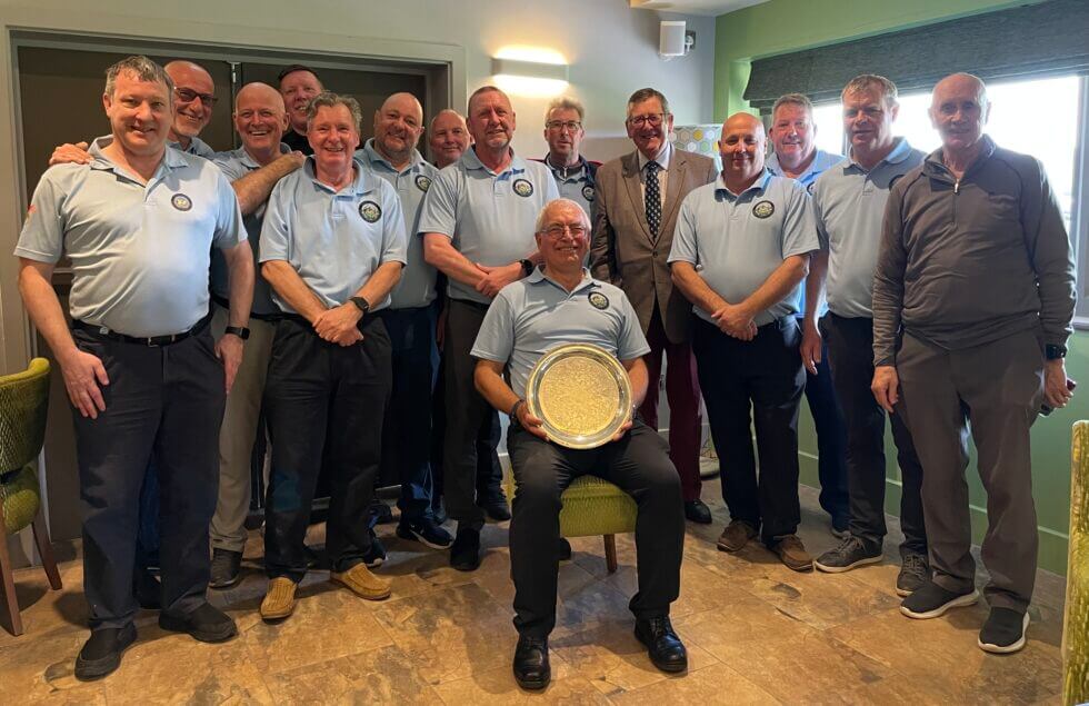 image of the winning team, East Kent, gathered for a group photo with the Silver Salver being held by one of the golfers. 