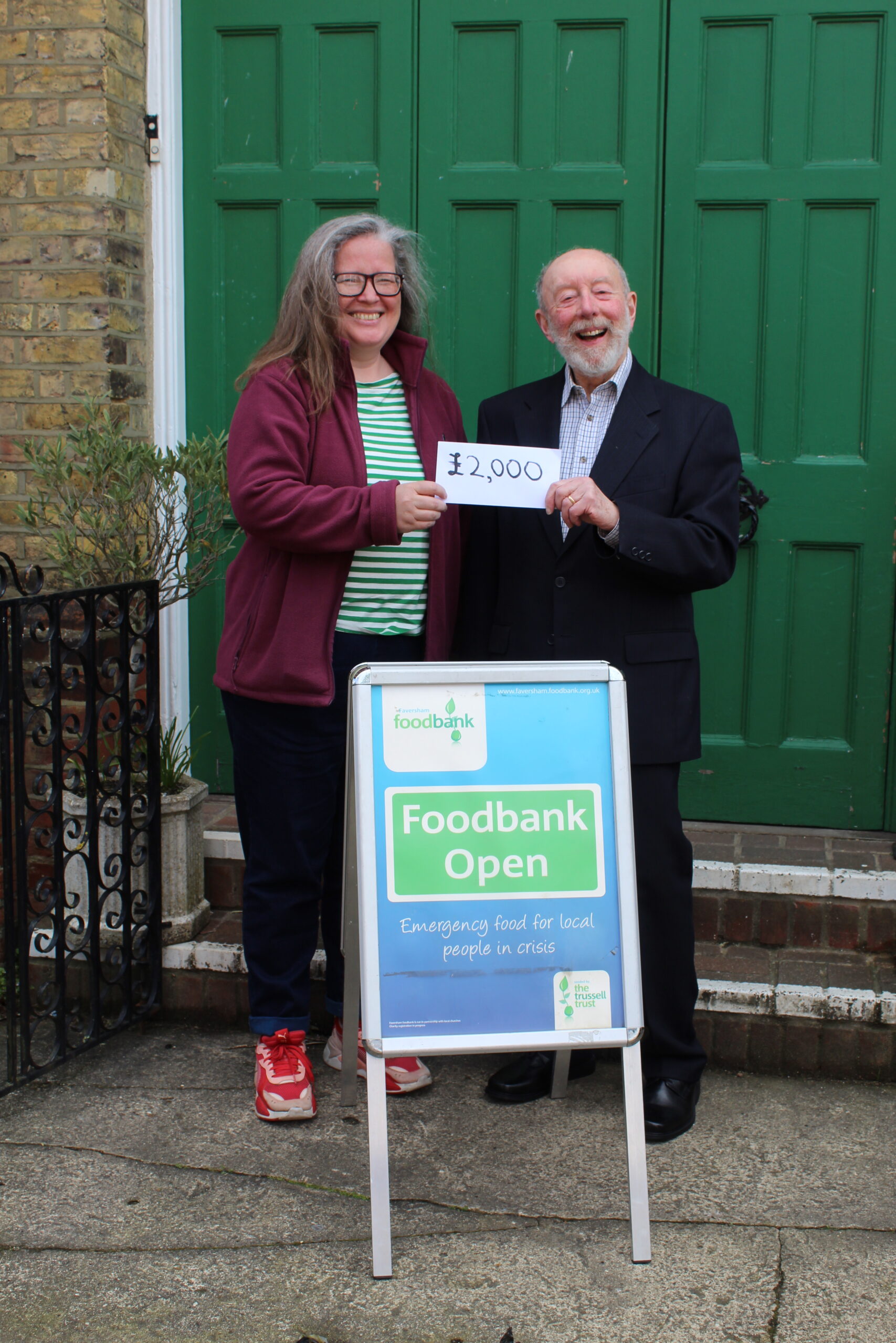 A picture of the cheque for £2000 being presented by Ernie, who handed over the cheque to Magdalen Deakins, Faversham Foodbank's project.