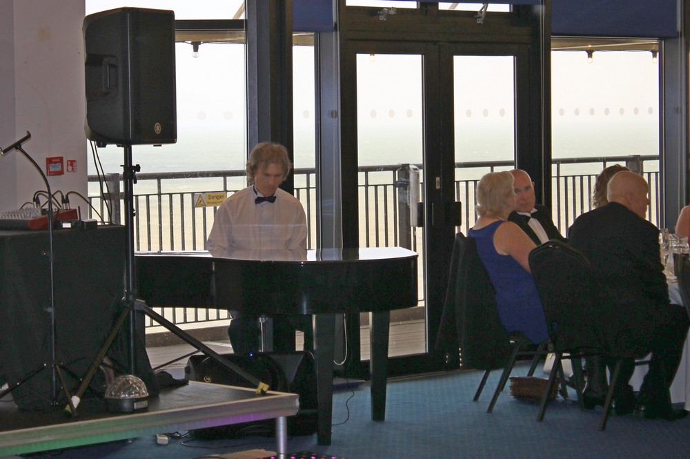 Picture of  Lawrie Bolton, the Pianist entertaining everyone before the ball started and during the meal.