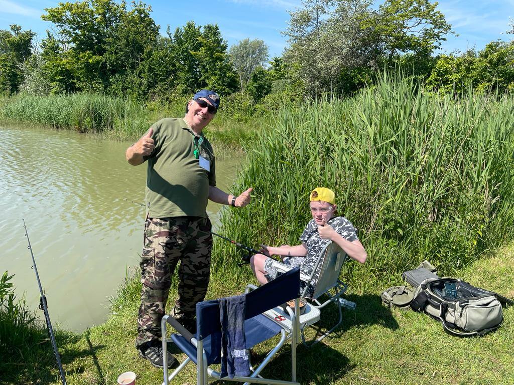Caster and student giving the thumbs up to the fishing