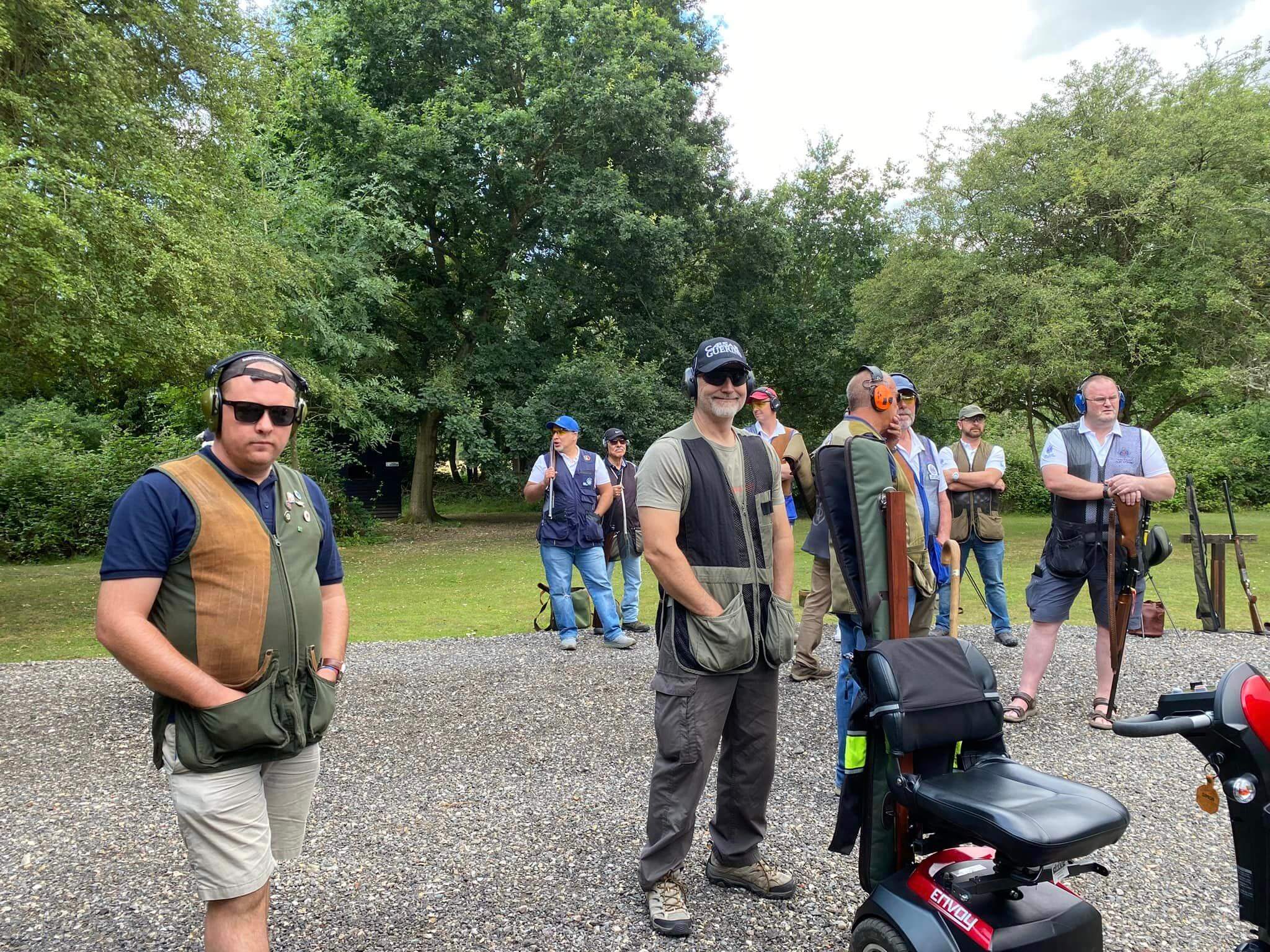 photo of members of the team waiting to take their turn shooting. 