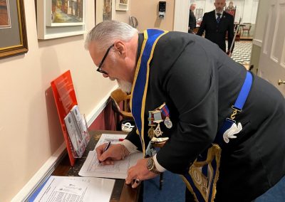 WBro Kevin Stones signs the visitors book.
