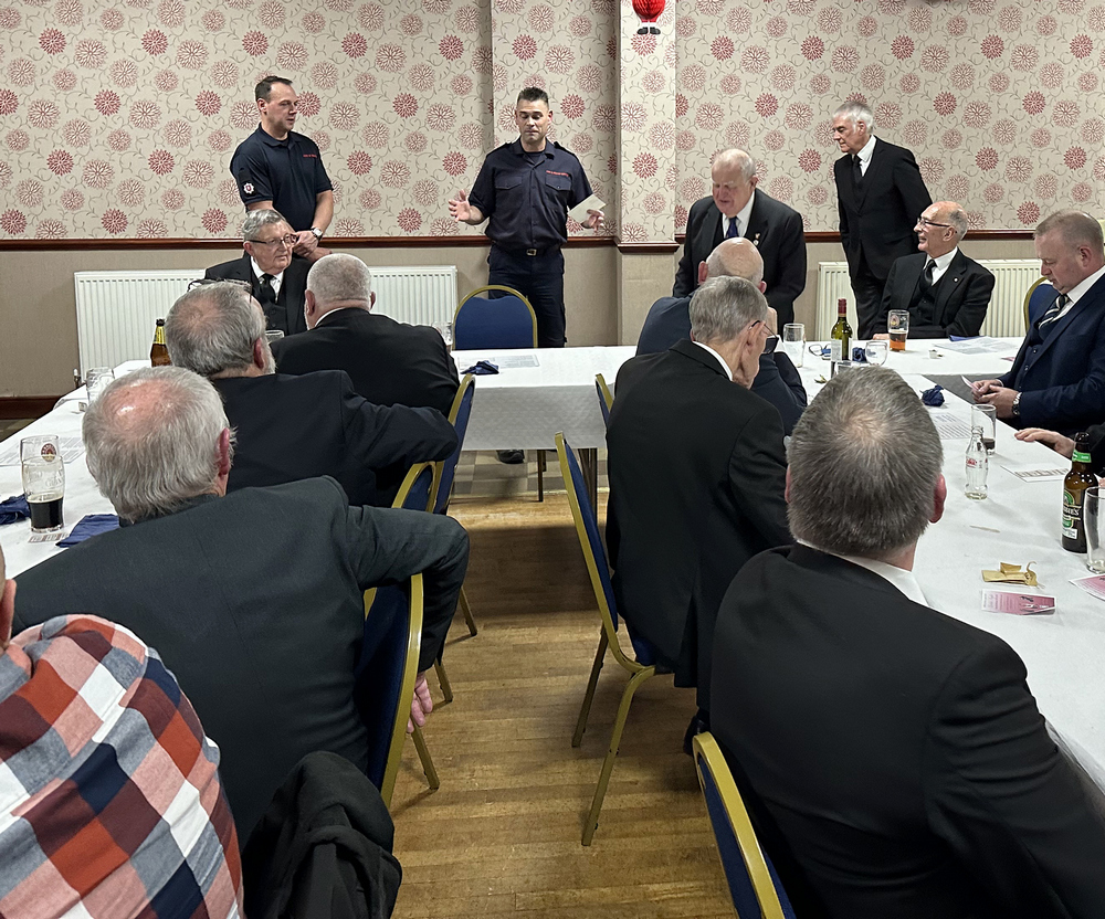 Members of Kent Fire and Rescue at the Festive Board talking to the Lodge members and guests